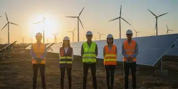 Professionals at a solar and wind energy site, symbolizing clean energy careers.