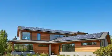 Modern home with solar panels on roof under bright sun